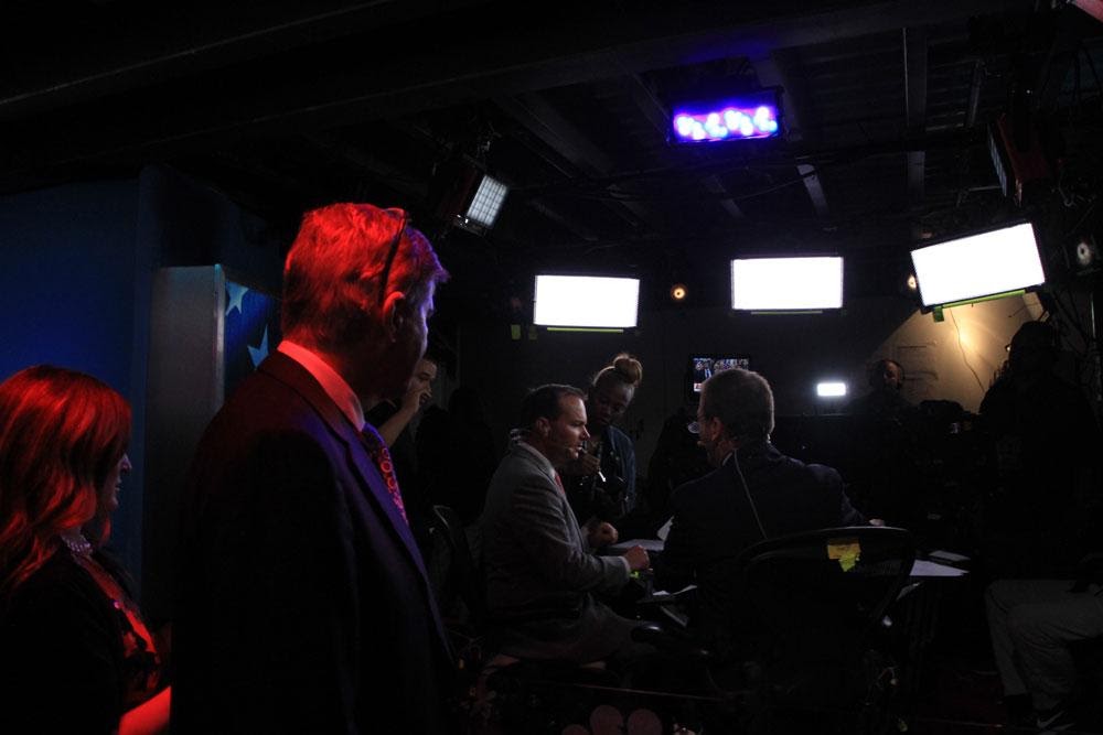 news team prepares for a shoot in a dark studio during the 2016 Democratic National Convention