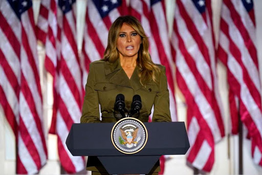 Melania Trump addresses a crowd from a podium